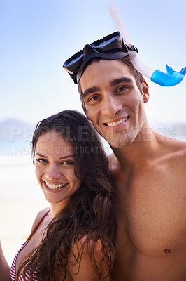 Buy stock photo Love, smile and portrait of happy couple at ocean for tropical holiday adventure, relax or bonding together. Nature, man and woman on romantic date with beach, blue sky and snorkel vacation on island
