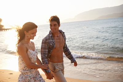 Buy stock photo Love, sunset and couple walking at ocean for tropical holiday adventure, relax and bonding together. Nature, man and woman on romantic date with beach, island and evening waves on happy vacation.