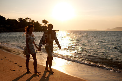 Buy stock photo Love, sunset sky and couple walking at ocean for tropical holiday adventure, relax and bonding together. Nature, man and woman on romantic date with beach, island and evening waves on happy vacation.