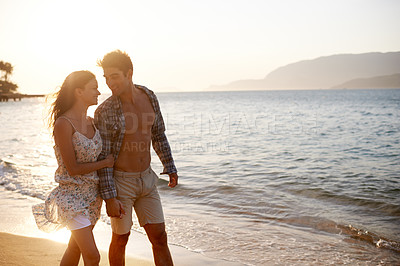 Buy stock photo Love, waves and happy couple walking at ocean for tropical holiday adventure, relax and bonding together. Nature, man and woman on romantic date with beach, sunset sky and connection on vacation.