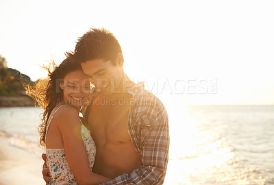 Buy stock photo Love, embrace and happy couple at beach sunset for tropical holiday adventure, relax and bonding together. Nature, man and woman smile on romantic date with ocean, sky and hug on island vacation