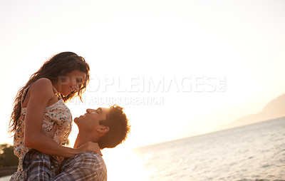 Buy stock photo Beach, man lifting woman and ocean for travel, anniversary or date with bonding, love and support. Happy, freedom and fresh air in nature, couple outdoor and sunset, trust and hug in relationship