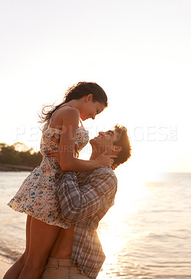 Buy stock photo Shot of a young couple enjoying a beach getaway