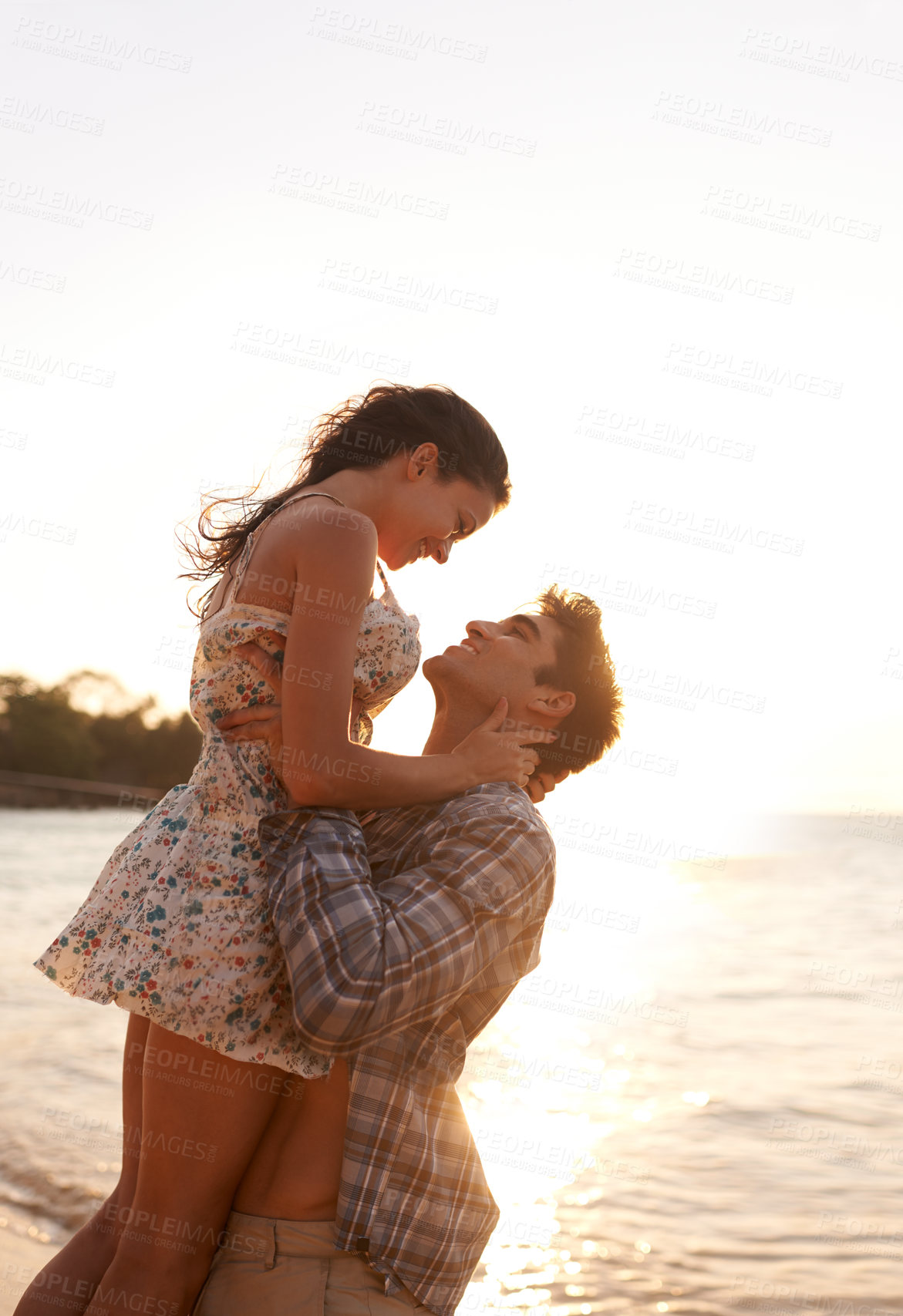 Buy stock photo Shot of a young couple enjoying a beach getaway