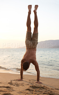 Buy stock photo Man, beach and handstand for holiday travel on tropical island for ocean adventure, sunshine or weekend. Male person, sand and seaside fun in evening at tourism coast for break, outdoor or explore