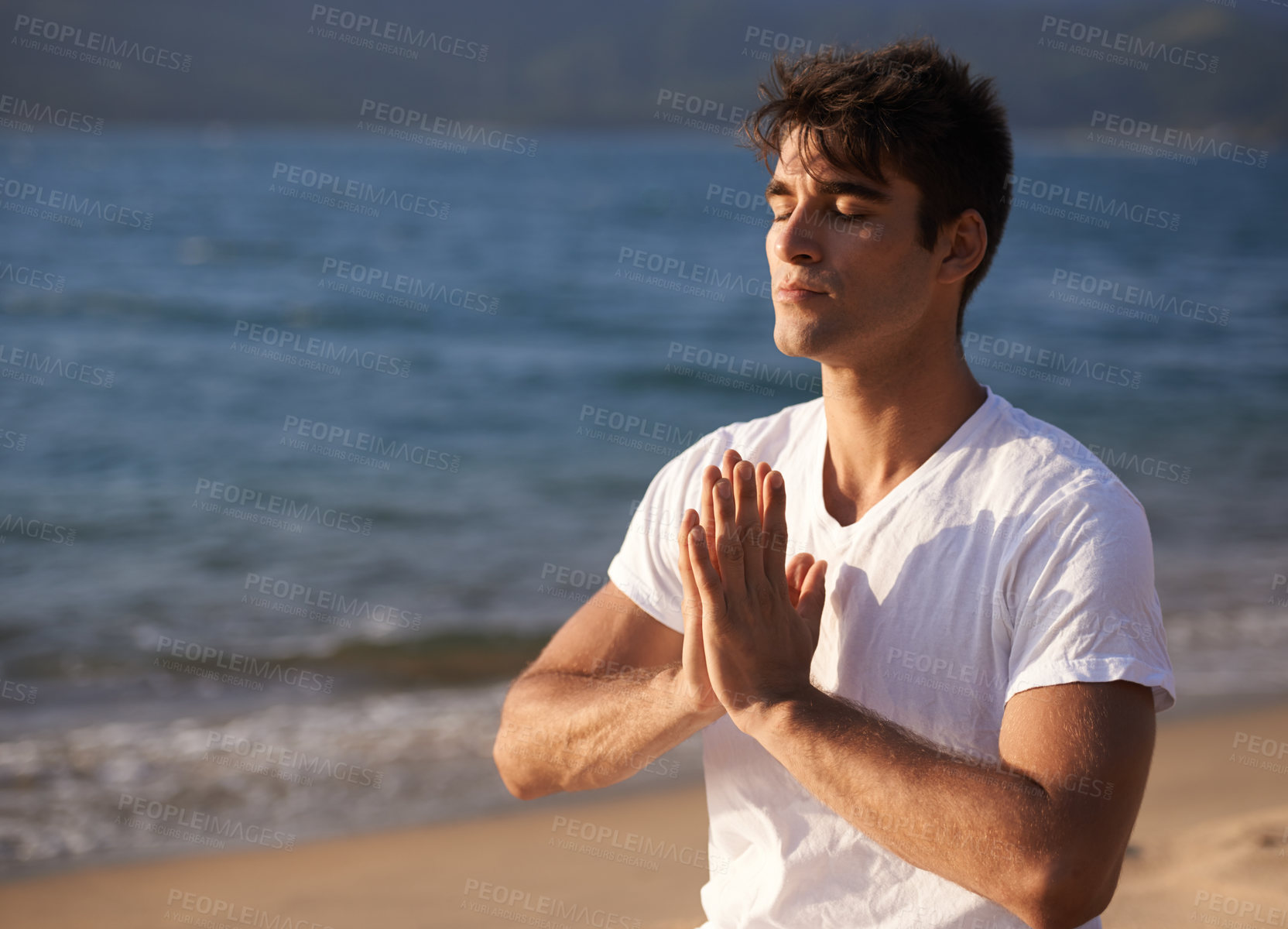 Buy stock photo Meditate, hands with prayer and man on beach, mindfulness and zen with fresh air for calm outdoor. Ocean, seashore and travel with yoga for health, peace of mind and holistic healing for aura