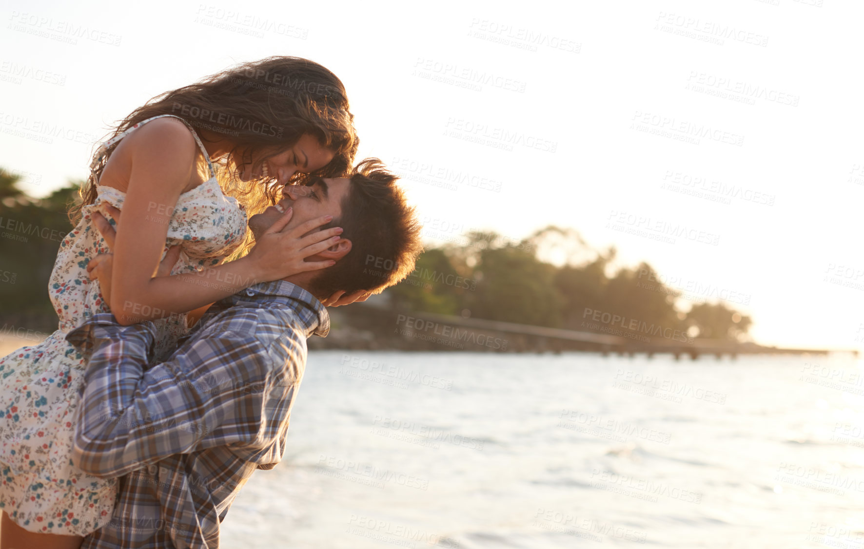 Buy stock photo Shot of a young couple enjoying a beach getaway