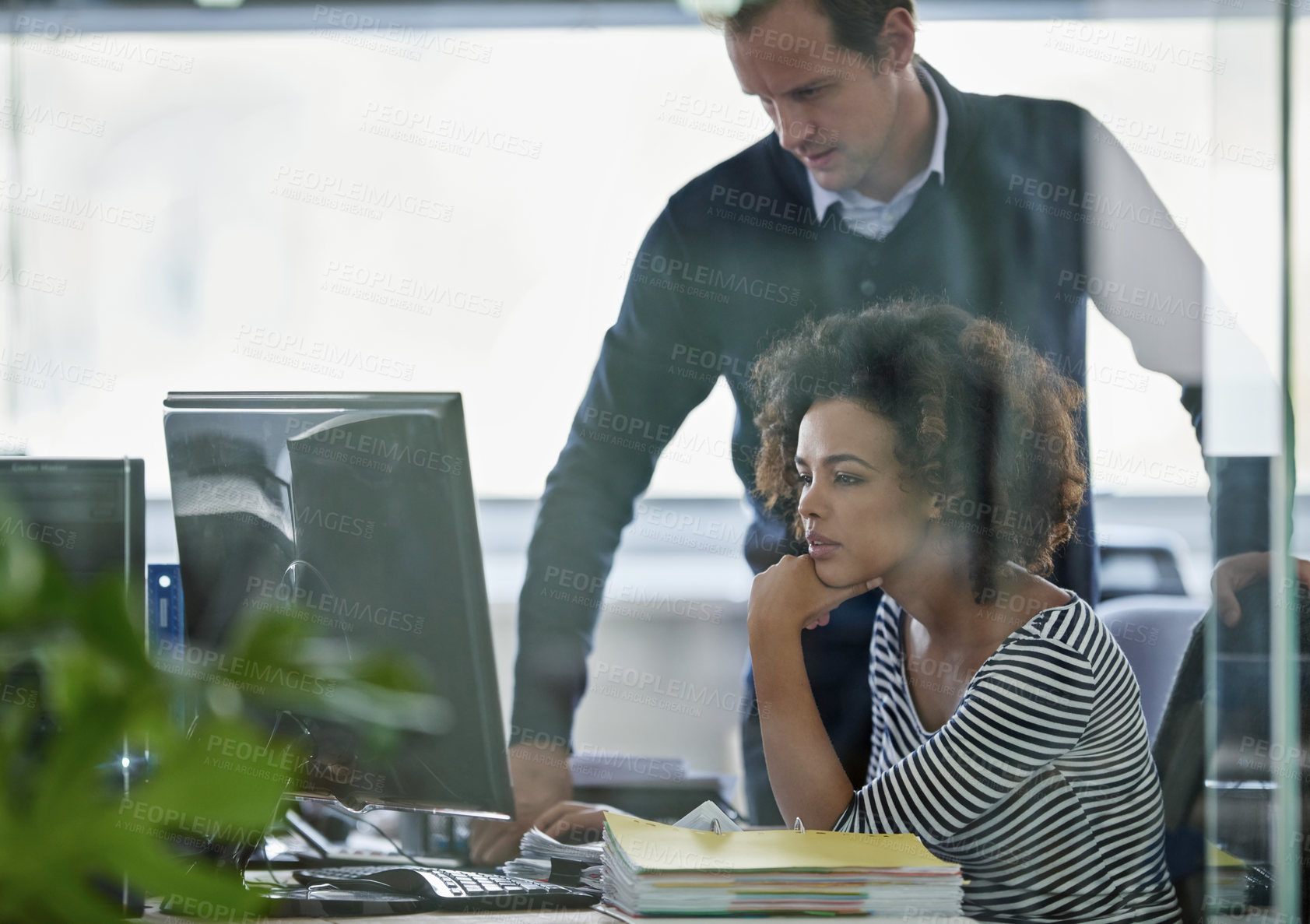 Buy stock photo Cropped shot of two young designers working on a pc