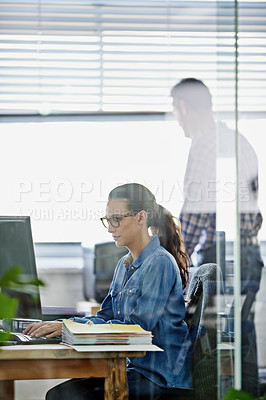 Buy stock photo Cropped shot of an attractive young designer working on a pc