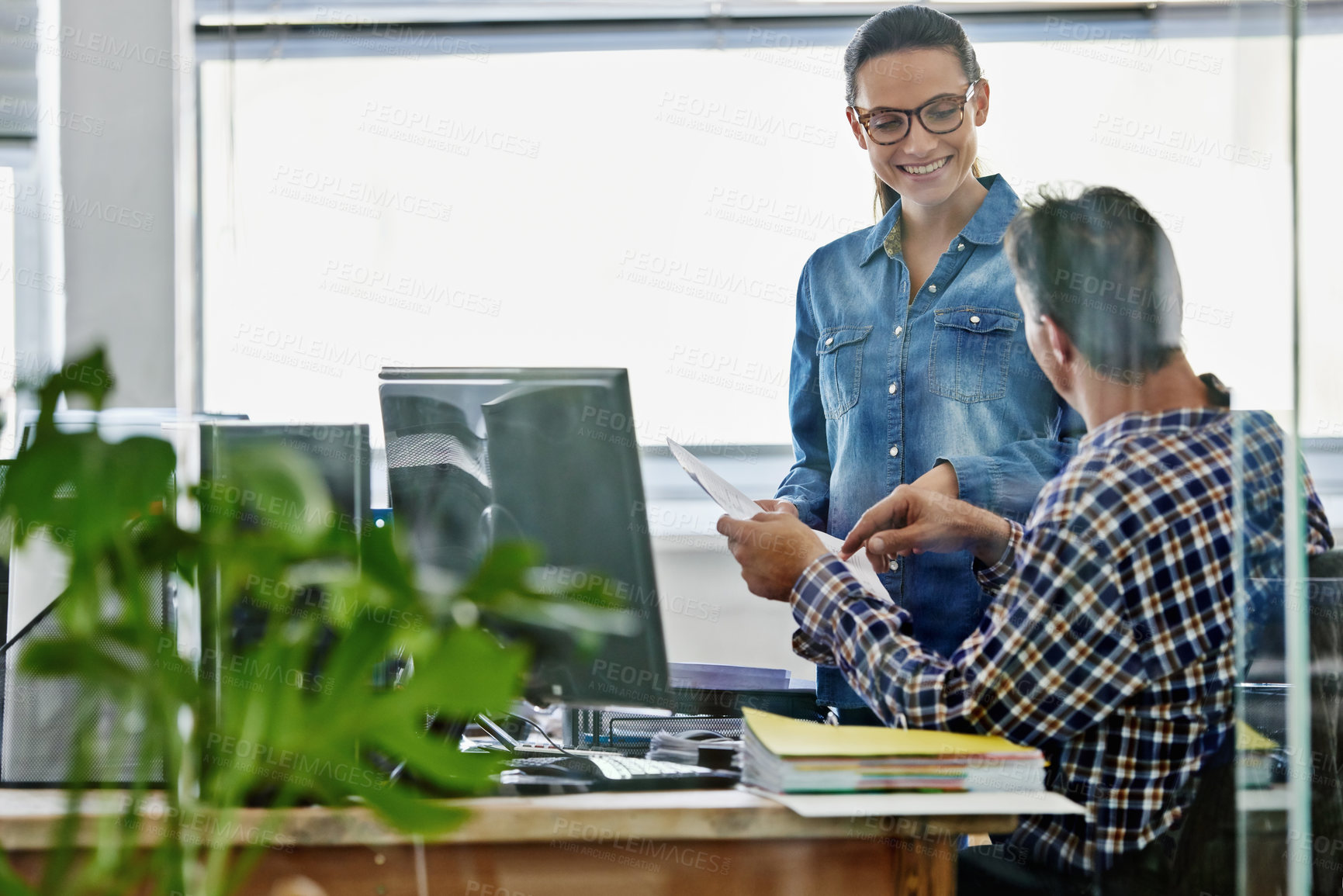 Buy stock photo Cropped shot of two young designers working on a pc