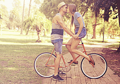 Buy stock photo Couple, kiss and park with bike, date and relaxation for relationship bonding and love. Man, woman and bicycle with nature, grass and care for new york travel and adventure on holiday or honeymoon