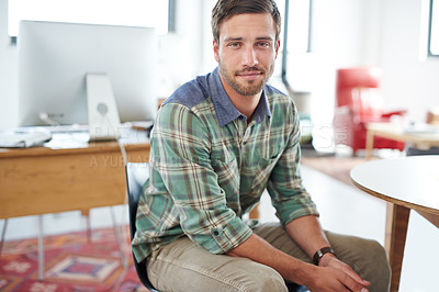 Buy stock photo Portrait of a casually-dressed young man sitting in an office