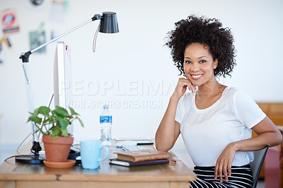 Buy stock photo Portrait of an attractive young woman sitting at her workstation in the office. The commercial designs displayed represent a simulation of a real product and have been changed or altered enough by our team of retouching and design specialists so that they don't have any copyright infringements