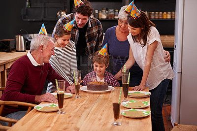 Buy stock photo Family, birthday cake and happy kid with mom, dad and grandparents together with people and candles. Youth, smile and dessert with children and celebration with event food and party hats at a table