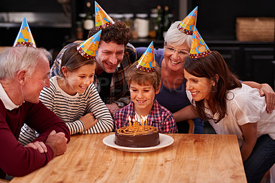 Buy stock photo Shot of a happy young boy celebrating his birthday with his family 