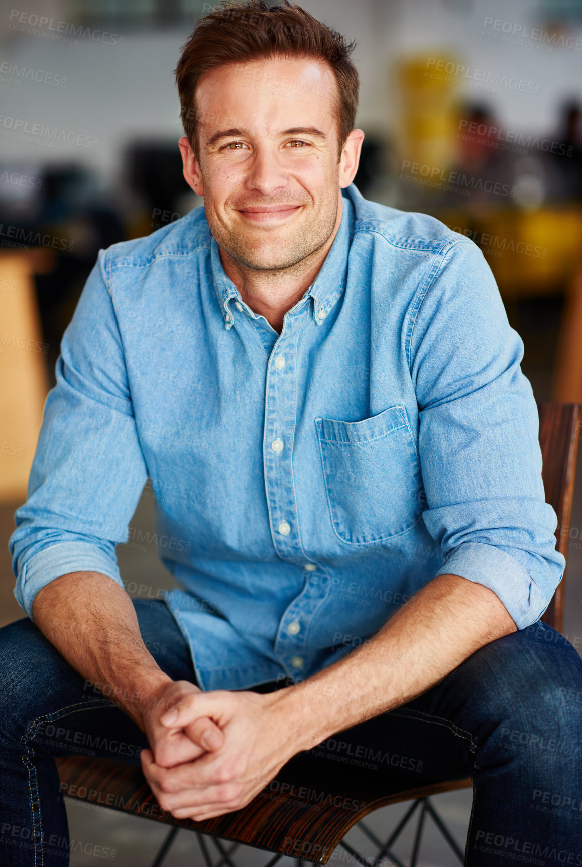 Buy stock photo Portrait of a handsome young designer sitting on a chair in an office