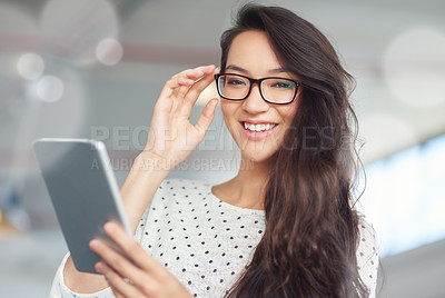 Buy stock photo Portrait of a attractive young woman using a digital tablet in an office