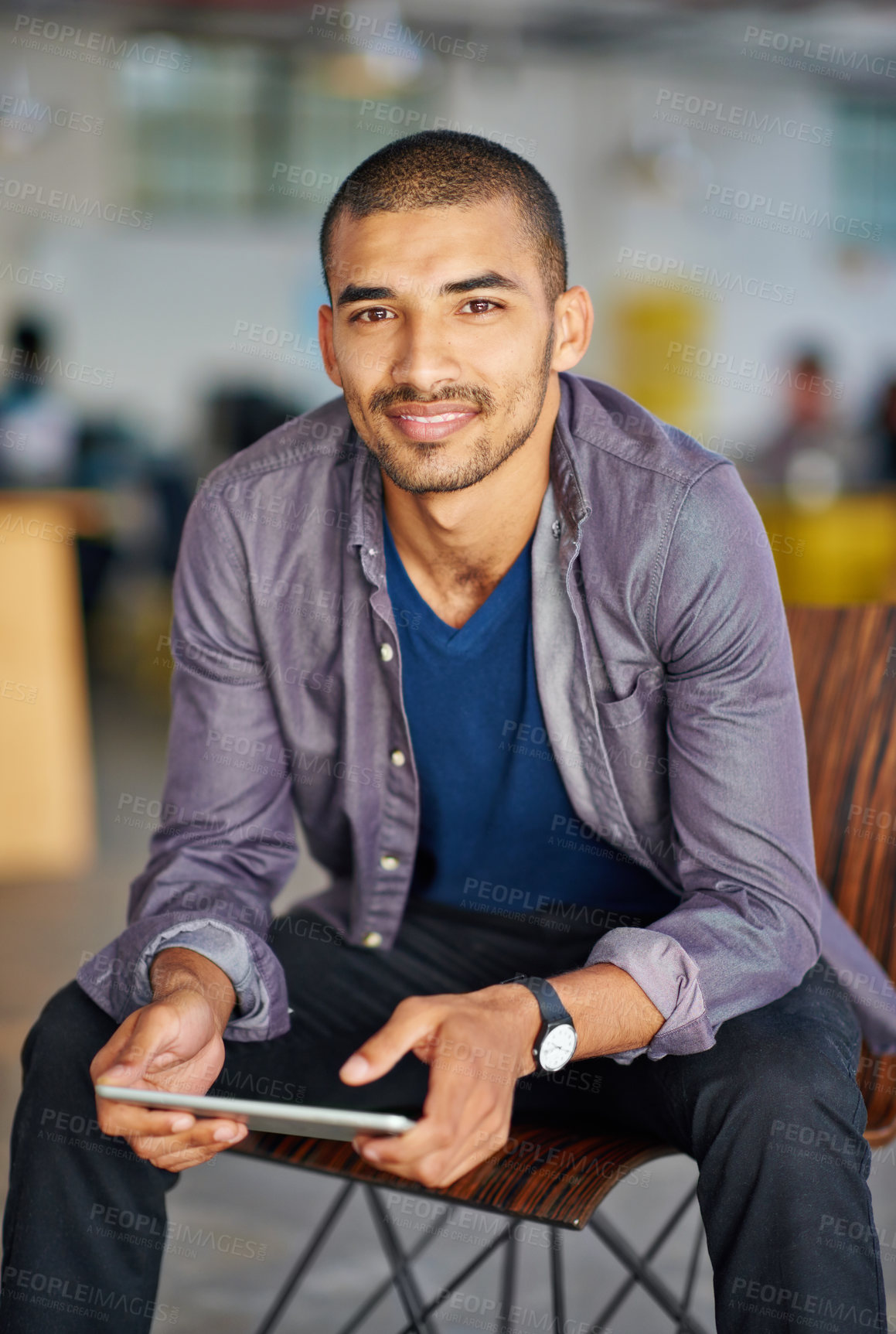 Buy stock photo Portrait of a handsome young man using a digital tablet in an office