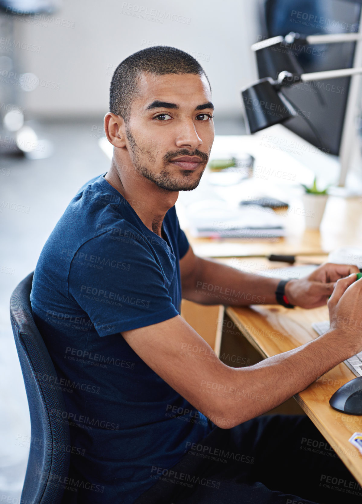 Buy stock photo Portrait, serious and business man at desk in office of creative startup for career or job of male person in Brazil. Face, professional and confident entrepreneur at table, designer and employee