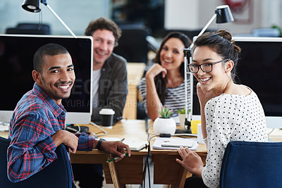 Buy stock photo Portrait of a group of young office workers sitting at their computers