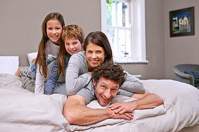 Buy stock photo Stack, bed and family with portrait, kids and relaxing with happiness and bonding together with smile. Home, mother and father with parents and children with fun and bedroom with joy, play or morning