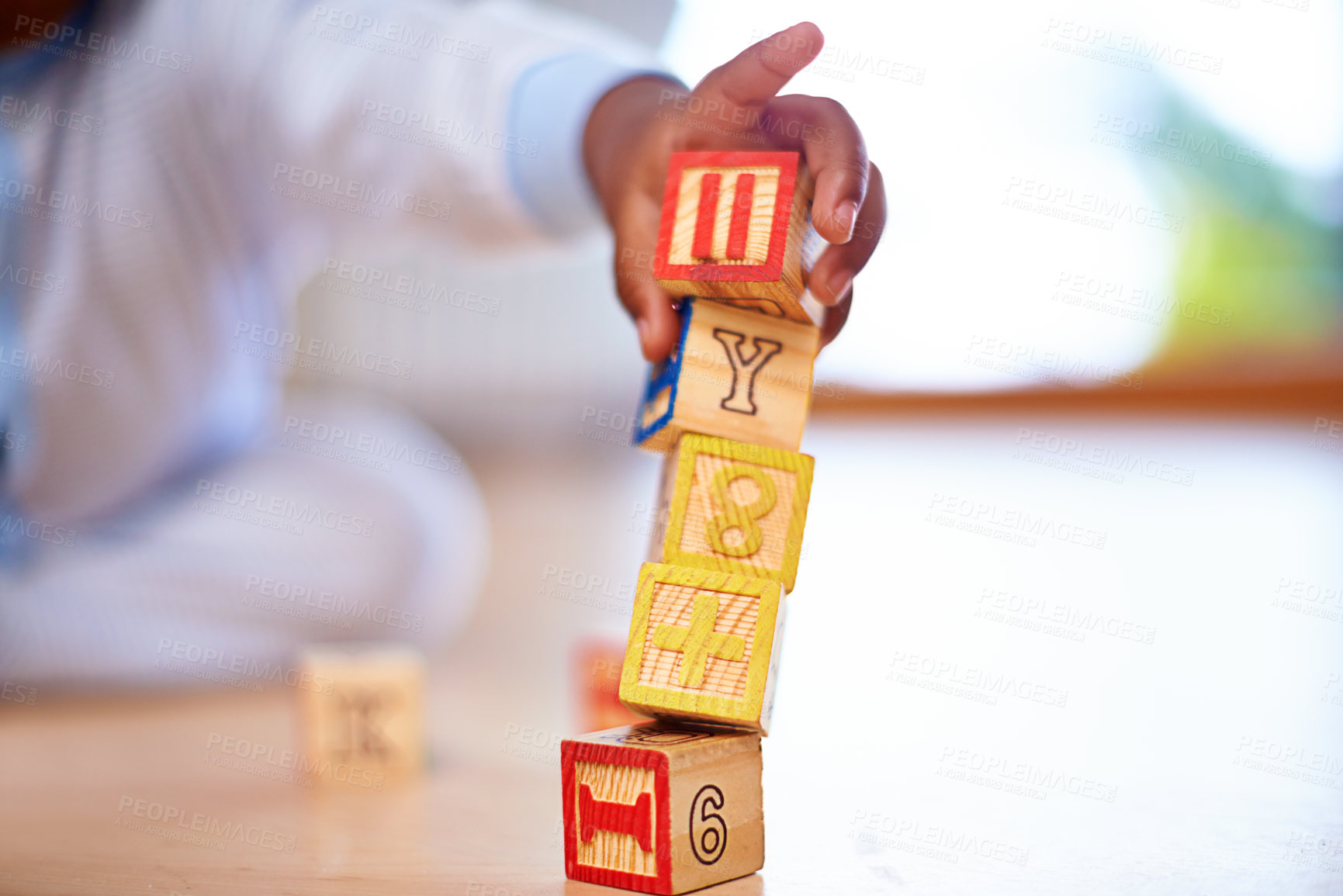 Buy stock photo Wooden blocks, baby and hands on floor in house in living room with toys for motor skills, growth and child development. Children games, kids and ground in home for learning, literacy and playing