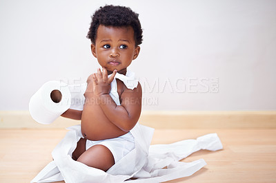 Buy stock photo Shot of a cute baby boy entangled in a roll of toilet paper