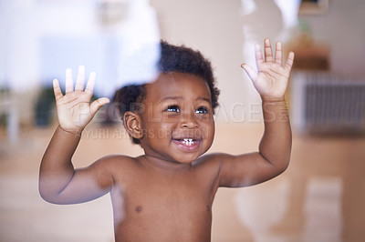 Buy stock photo Baby, happy and smile behind window, natural and child development for toddler growth in family home. Children, sensory education and touch with hand on glass, curious play with young African boy