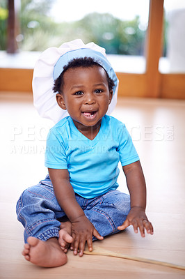Buy stock photo Black baby, portrait and chefs hat in house on floor for kids youth, playing and fun. African child, happy and smile in home in living room with toque for recreation, memories and family bonding