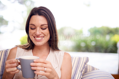 Buy stock photo Shot of an attractive young woman drinking coffee at home