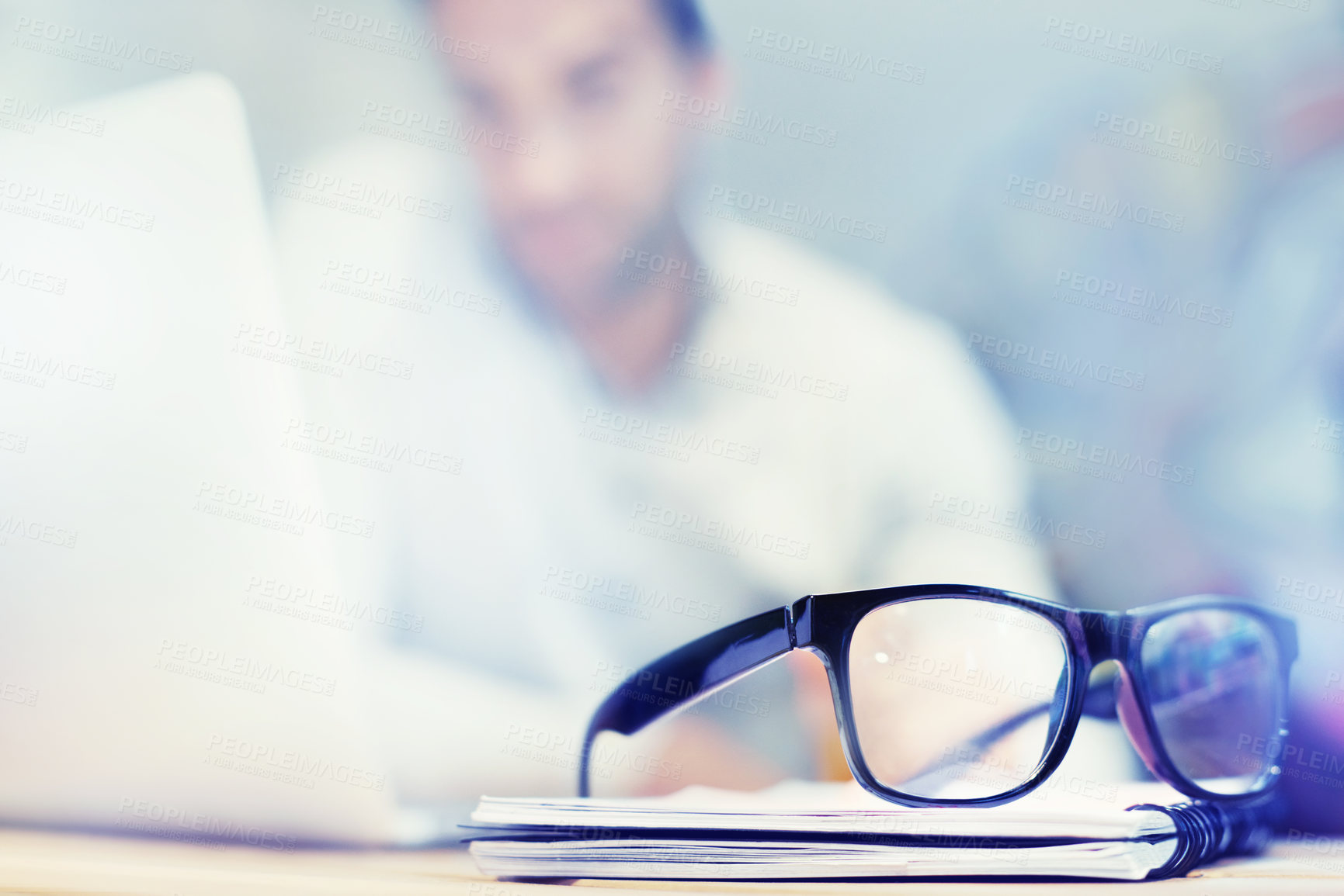 Buy stock photo Blur, notebook and glasses on desk with man in office for planning, schedule and agenda on table. Laptop, eyewear or worker copywriting with diary journal for business, administration or email on web