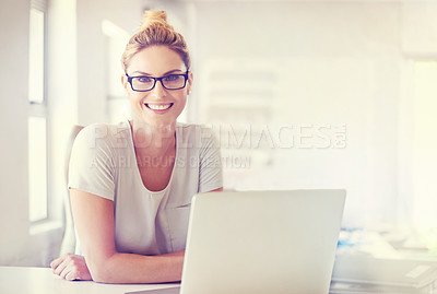 Buy stock photo Portrait of a happy woman working at her desk in a casual office environment