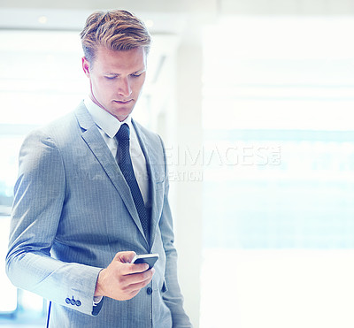 Buy stock photo Businessman, phone and typing at office for social media, communication or networking on mockup space. Young man, lawyer or employee on mobile smartphone for online chatting or texting at workplace