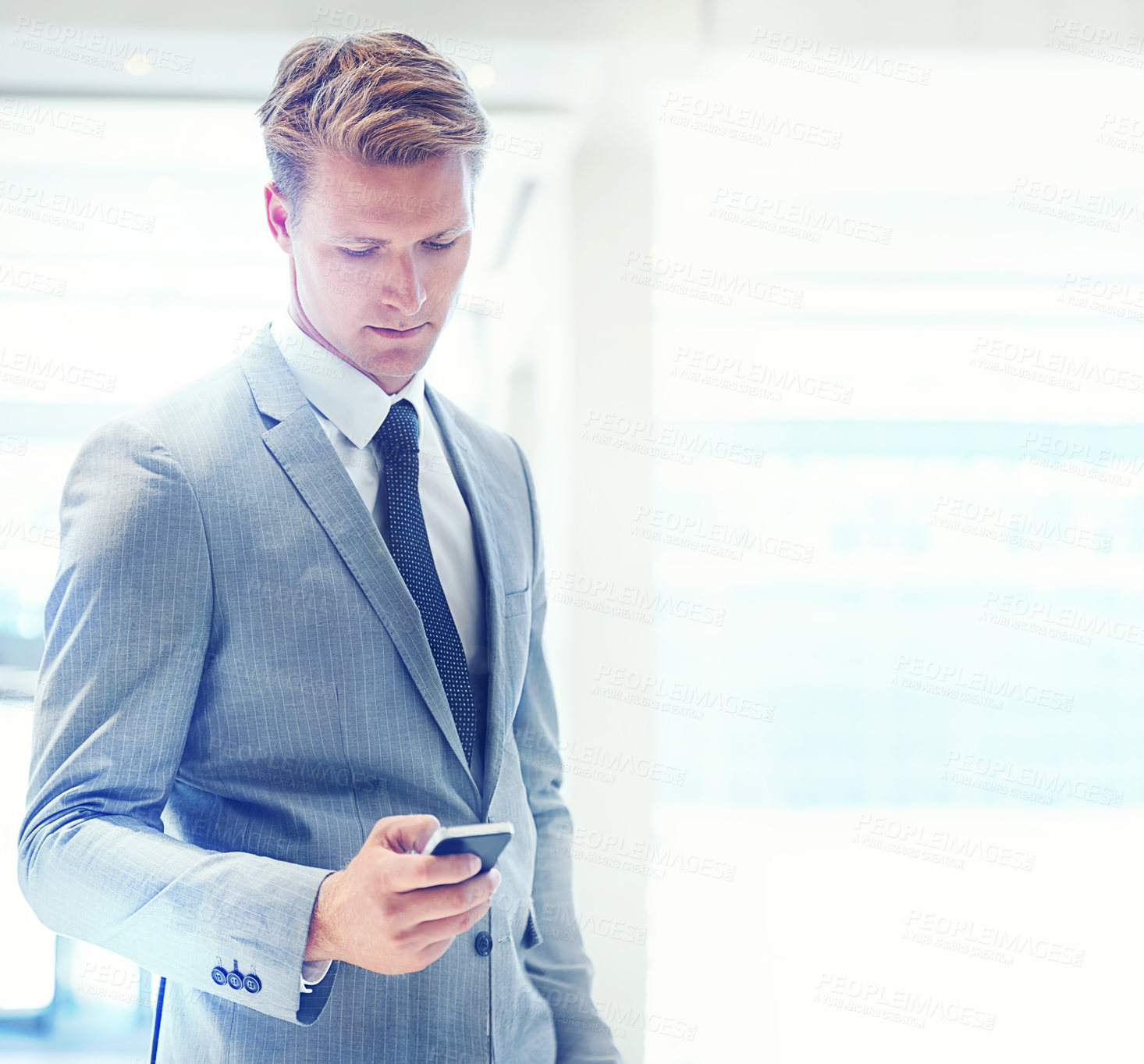 Buy stock photo Businessman, phone and typing at office for social media, communication or networking on mockup space. Young man, lawyer or employee on mobile smartphone for online chatting or texting at workplace