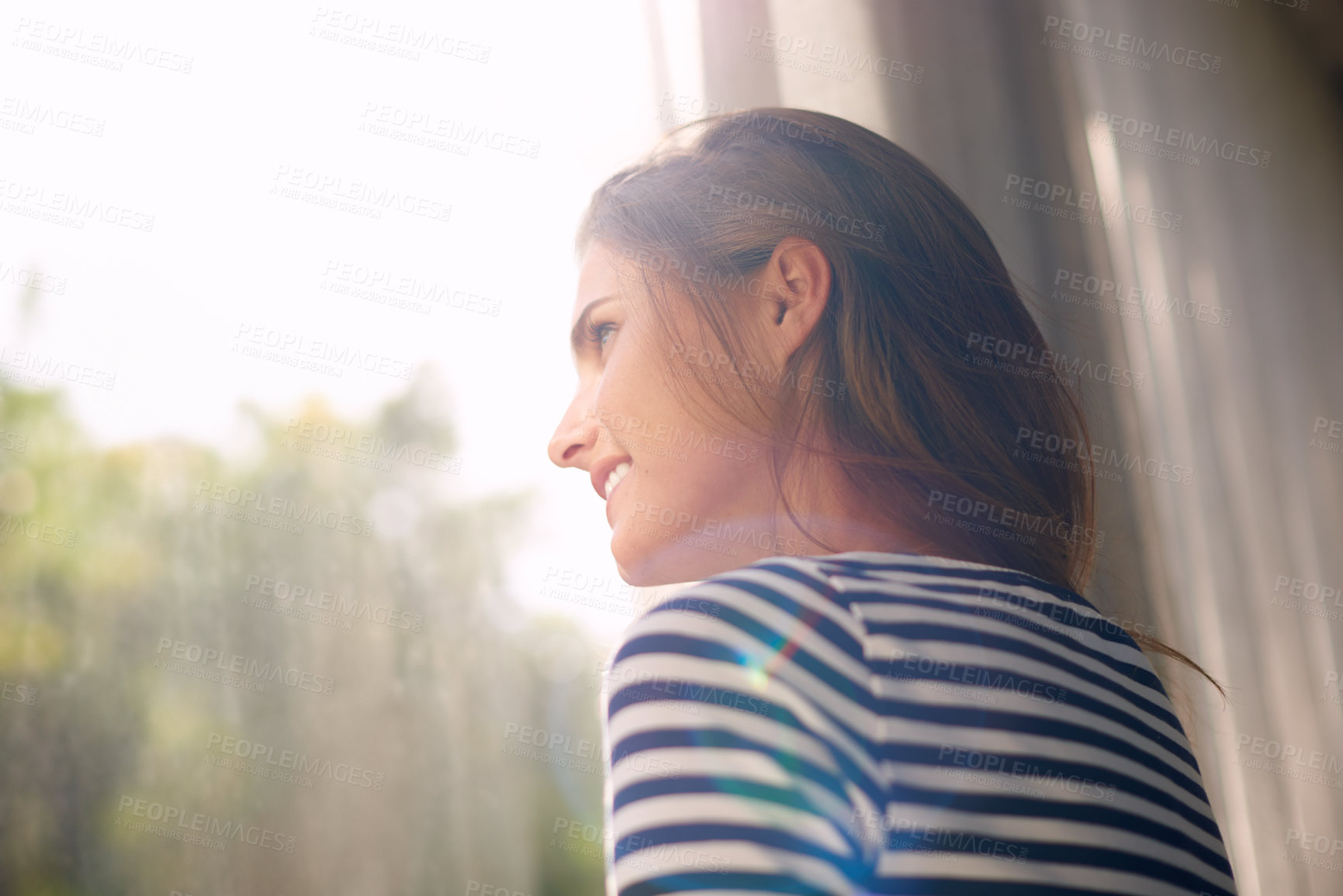 Buy stock photo Cropped shot of a beautiful young woman bathed in window light