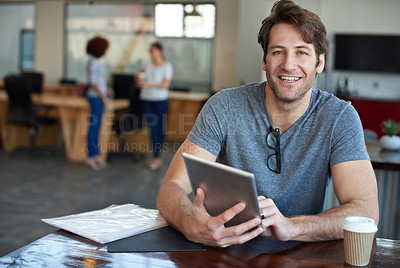 Buy stock photo Portrait of a young man using a digital tablet in an office