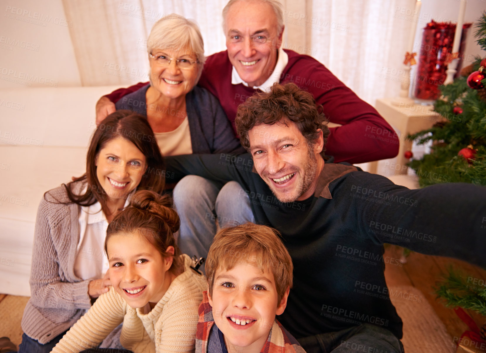 Buy stock photo Big family, portrait smile and Christmas selfie relaxing for quality bonding together at home. Mother, father and grandparents with kids smiling for festive holiday, celebration or family photo time