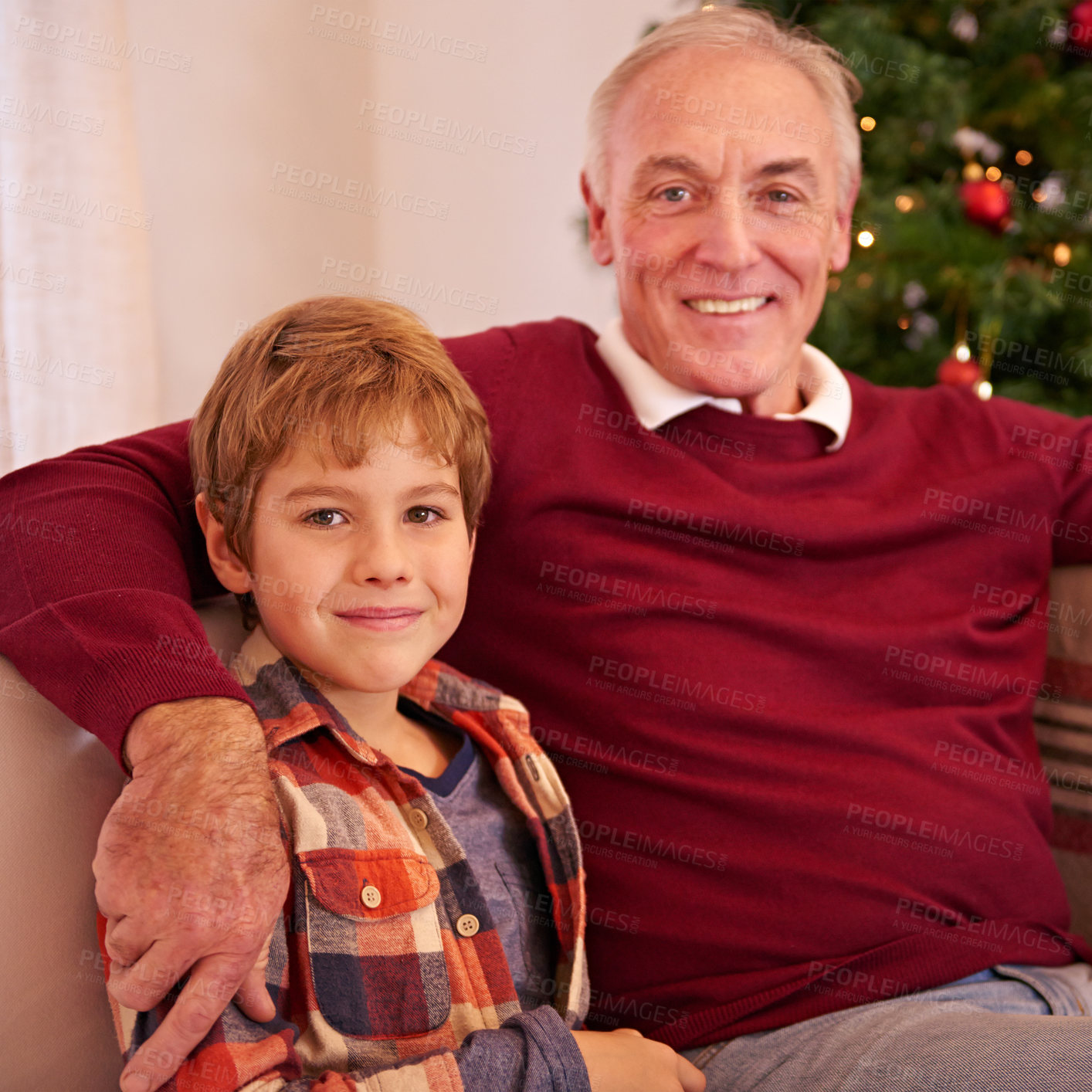 Buy stock photo Elderly man, grandson and christmas portrait on sofa with love, bonding or happiness in family home. Boy, grandfather and smile together for celebration, holiday or happy on couch in house by tree