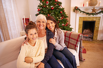 Buy stock photo Grandmother, mother and girl on sofa at Christmas enjoying holiday, vacation and festival celebration. Family, love and and portrait of mom bonding with grandma and child with Christmas tree in home