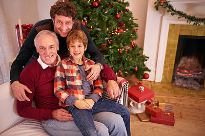 Buy stock photo Portrait of a grandfather, father and child at a christmas event relaxing on sofa together. Happy, smile and senior man in retirement sitting with dad and boy kid at festive xmas celebration at home.