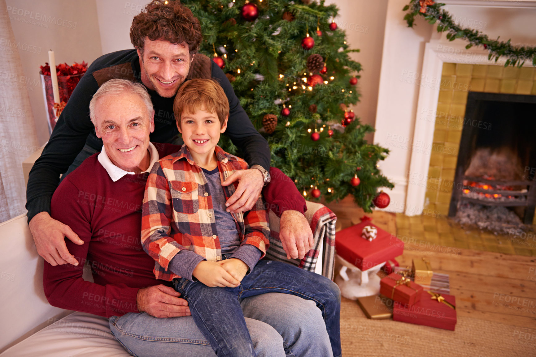 Buy stock photo Portrait of a grandfather, father and child at a christmas event relaxing on sofa together. Happy, smile and senior man in retirement sitting with dad and boy kid at festive xmas celebration at home.