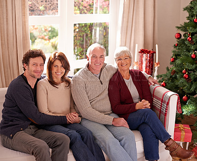 Buy stock photo Christmas, family and together on sofa for portrait in living room to celebrate festive holiday. Quality time, relax and happy family relax for bonding, support and care on couch for celebration