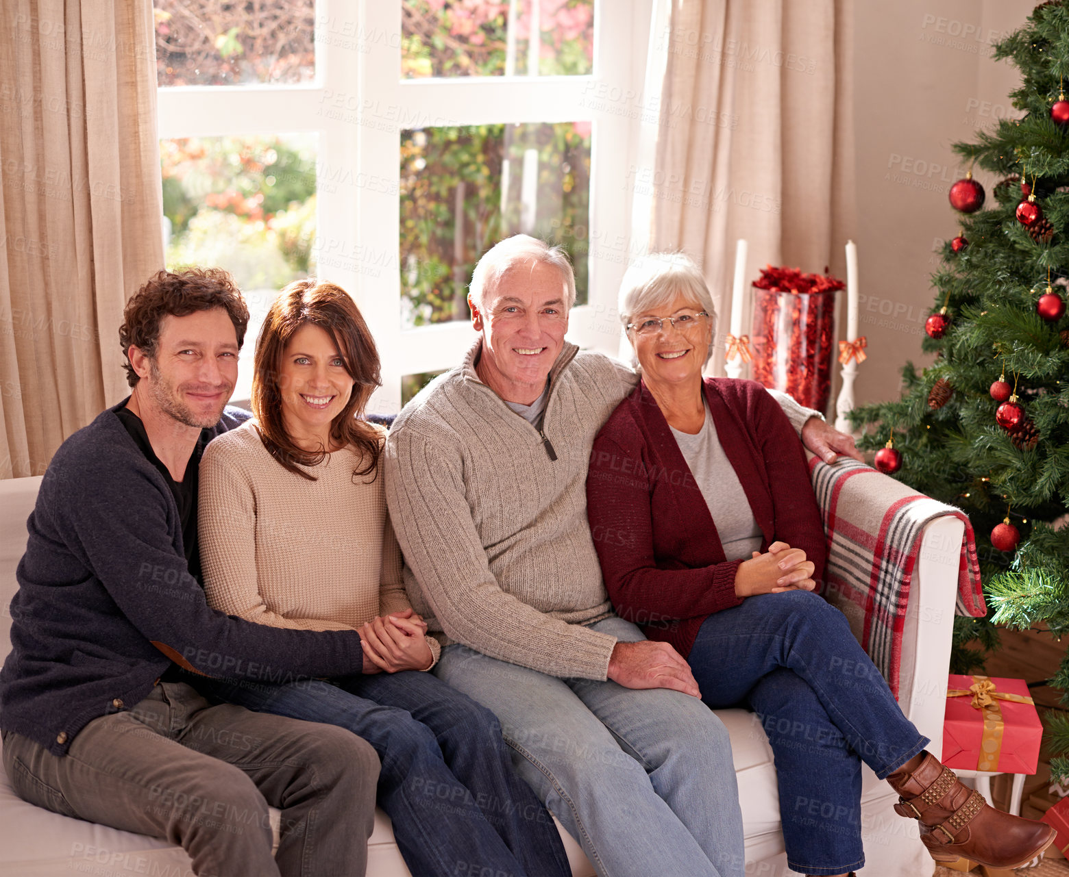 Buy stock photo Christmas, family and together on sofa for portrait in living room to celebrate festive holiday. Quality time, relax and happy family relax for bonding, support and care on couch for celebration