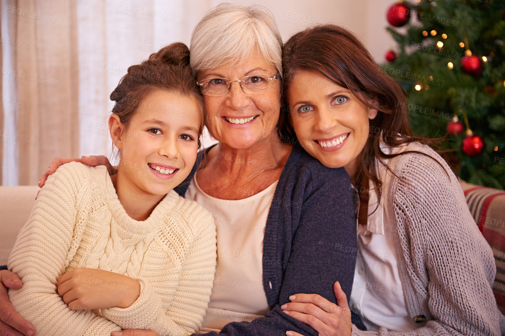 Buy stock photo Portrait of grandmother, mother and girl at Christmas on sofa bonding, loving and enjoying holiday season together. Family, love and child with grandma and mom on festive, celebration and vacation