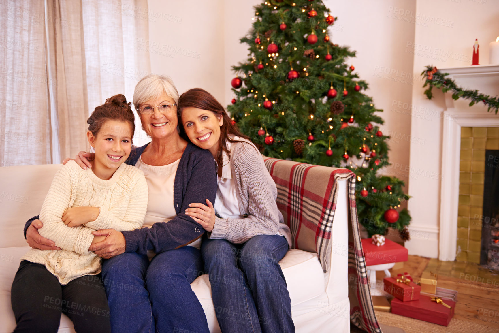 Buy stock photo Christmas, portrait and family on sofa by mother, girl and grandma in celebration of bonding tradition in their home. Happy family, generations and women embrace in living room for festive vacation 