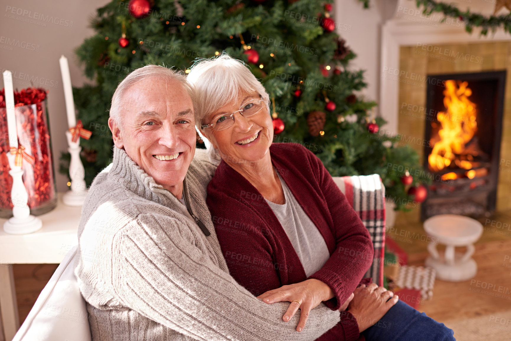 Buy stock photo Portrait, senior and couple on a sofa for christmas celebration, happy and relax in a living room in their home. Fcae, seniors and woman with man on a couch, embrace and enjoy festive spirit together