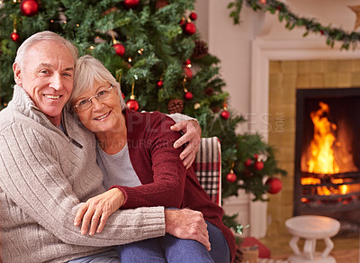 Buy stock photo Love, portrait and senior couple at a christmas party or celebration relaxing in the living room of their home. Happy, smile and elderly man and woman embracing at a festive xmas event at a house.