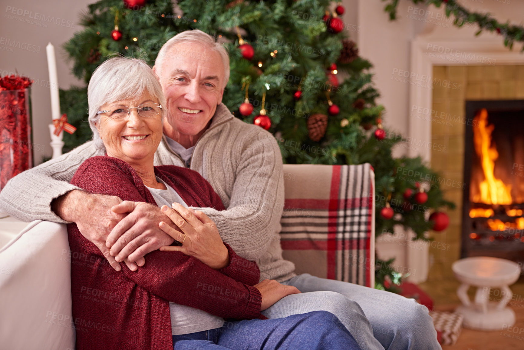 Buy stock photo Christmas, senior couple and on couch together for happiness, festive season and relax at home. Xmas, love and elderly man with mature woman, happy or smile for bonding, content and on sofa in lounge