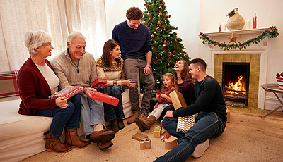 Buy stock photo Big family, christmas and gift in home living room for celebration, happiness and bonding together. Happy family, grandparents and children with present, giving and box with love, holiday or lounge