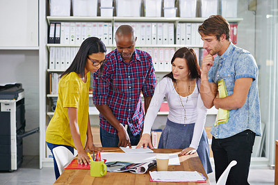 Buy stock photo Shot of a team of design professionals working together in an office